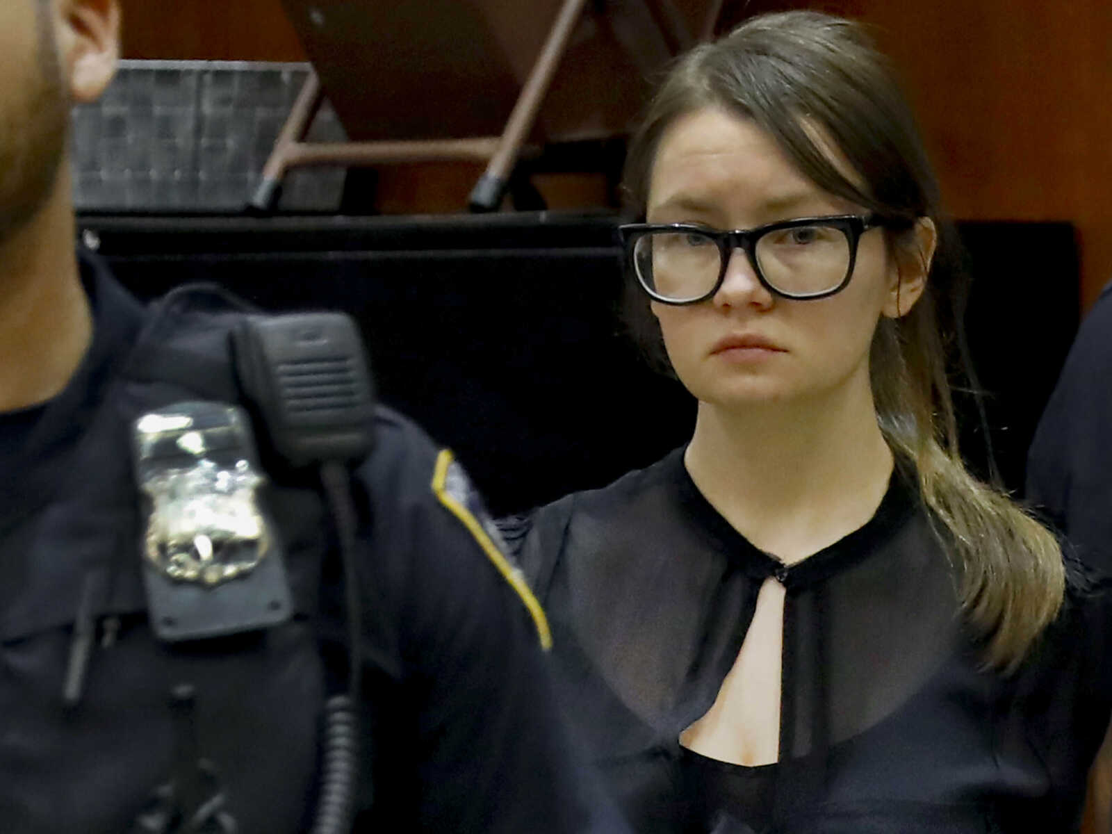 Anna Sorokin in black at courthouse