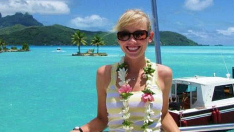 Sherry Papino standing in front of a boat