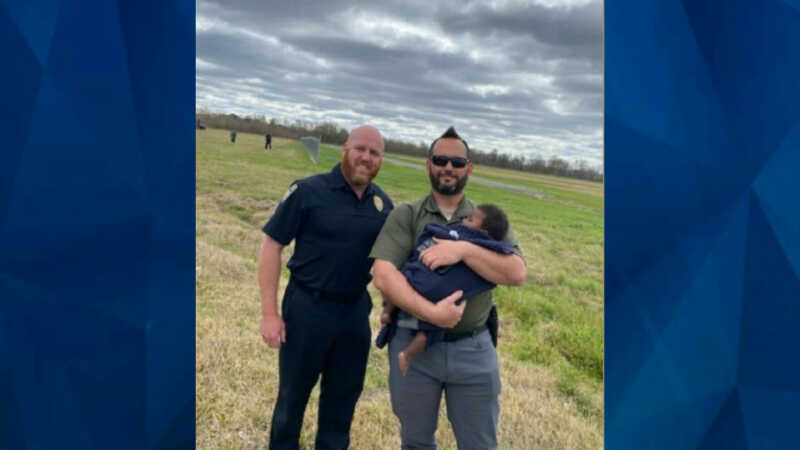 baby in field with Baton Rouge EMS