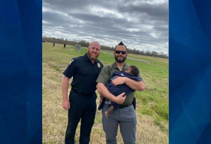 baby in field with Baton Rouge EMS