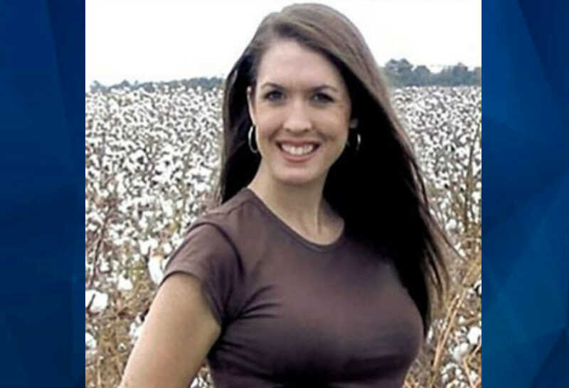 Tara Grinsted smiling, standing in front of cotton field