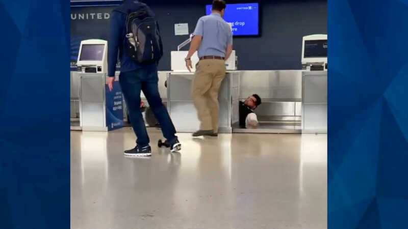 United Airlines employee falls on baggage belt during fight