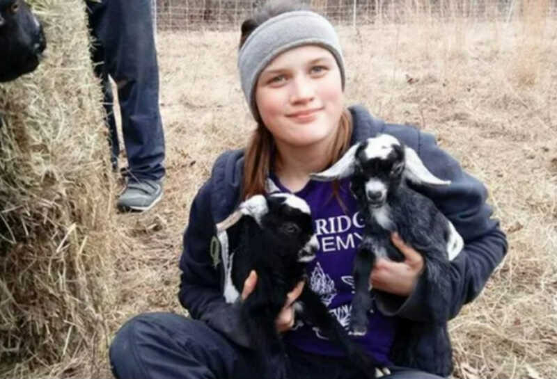 Savannah Leckie holding farm animals