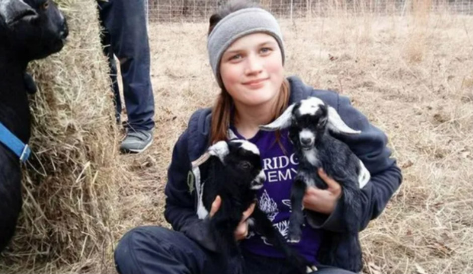Savannah Leckie holding farm animals