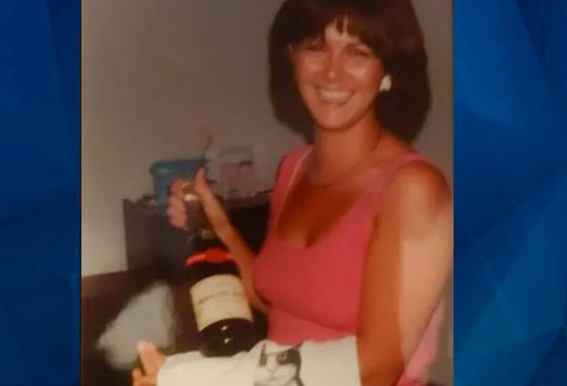 Christine Belusko with bottle of wine