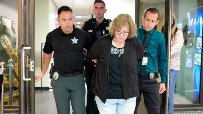 Police escort Susan Lorincz after her arrest