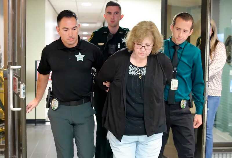 Police escort Susan Lorincz after her arrest